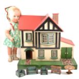 An Amersham Toys wooden dolls house and a composition doll.