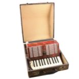 A Galotta piano accordion, red marbled body, 25 piano keys, in hard fitted case.