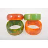 Four vintage coloured bakelite solid bangles,