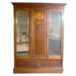 An Edwardian inlaid mahogany triple wardrobe.