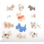 Twelve vintage celluloid and plastic Scottie dog brooches.