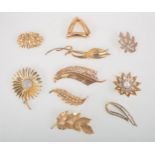 Ten vintage 1950's 1960's gilt metal brooches, Trifari, Nettie Rosenstein, Hollywood, Jewelcraft,