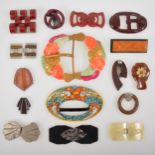 A collection of vintage costume jewellery bakelite, celluloid and plastic belt buckles and dress