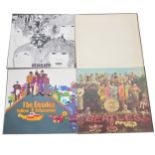 Four The Beatles LP vinyl records.