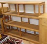 A contemporary oak four tier open shelf unit W.145cm