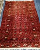 A Bokhara red ground rug 180 x 122cm