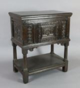 A late 17th century oak cupboard, with foliate, scroll and guilloche carved front panels, turned