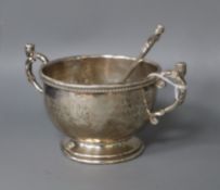 A George V Albert Edward Jones Arts and Crafts silver christening porringer and spoon, Birmingham,