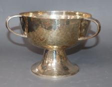 A George V planished silver tri-handled pedestal bowl by William Hutton & Sons, Sheffield, 1912,