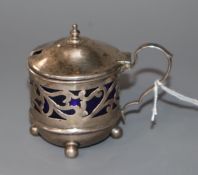 An Edwardian small pierced silver mustard pot, with blue glass liner, James Deakin & Sons,