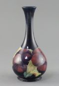 A Moorcroft 'pansy' bottle vase, c.1917, impressed marks Moorcroft Burslem England 50, inscribed