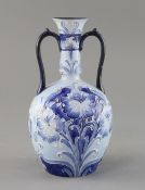 A Moorcroft Florian ware two handled vase, c.1900, decorated with blue and white flowers, brown