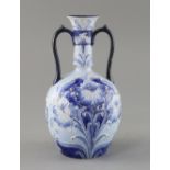 A Moorcroft Florian ware two handled vase, c.1900, decorated with blue and white flowers, brown