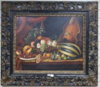 18th century style Dutch School, oil on canvas, still life with pomegranates, a melon and a violin