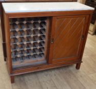 A marble top cabinet on stand incorporating a wine rack