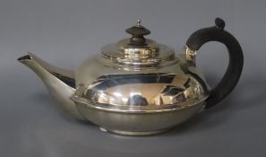 A George V silver squat circular teapot, Chester 1913, gross 14 oz.