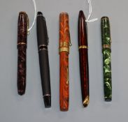 A group of five vintage fountain pens, including a Watermans orange and black marble effect pen with