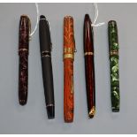 A group of five vintage fountain pens, including a Watermans orange and black marble effect pen with