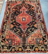 A Baktiari red ground floral rug 200 x 150cm