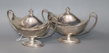 A pair of George III silver two handled boat shaped pedestal sauce tureens and covers, London,