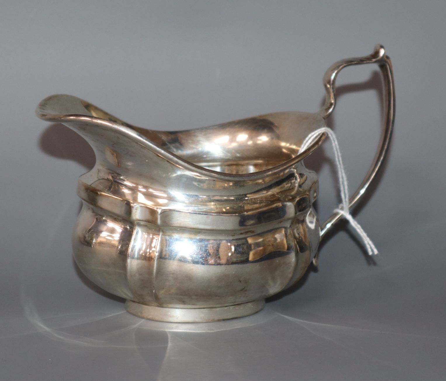 A George V silver helmet shaped cream jug, London, 1934.