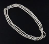 A triple strand freshwater? pearl necklace with white gold and diamond cluster set clasp, 68cm.