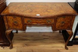 A Queen Anne Revival burr walnut serpentine front kneehole side table W.115cm