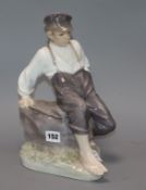 A Royal Copenhagen figure of a seated boy, modelled by Christian Thomsen, number 1659, 30cm height