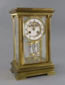 An early 20th century French ormolu four glass mantel clock, with enamelled Roman dial, visible