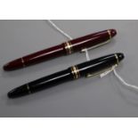 A Montblanc Meisterstuck burgundy fountain pen, 18K gold nib and a similar black-coloured pen