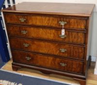 A Georgian style figured walnut four drawer chest W.114cm