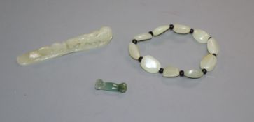 A Chinese pale celadon jade carving and a necklace