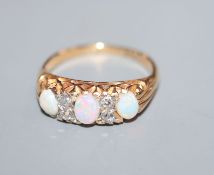 An 18ct and 'plat', white opal and diamond set half hoop ring, size K.