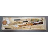 A collection of ivory Stanhope dip pens/paper knives, an ivory tape measure and bodkin case, a
