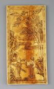 A Chinese ivory plaque, Qing dynasty, carved in relief with a sage and a lady in a pavilion