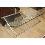 A contemporary glass and chrome X-frame rectangular coffee table W.142cm