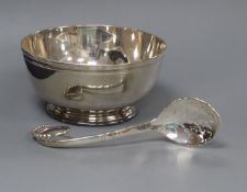 A George VI silver sugar bowl, London 1945 and a 1920's George Jensen sterling sifter spoon.