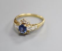 A modern 18ct gold, sapphire, round and square cut diamond set cluster ring, with diamond set