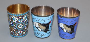 An early 20th century Russian 84 zolotnik and cloisonne enamel tot and two other white metal and