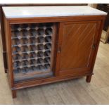 A marble top cabinet on stand incorporating a wine rack