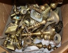 Approximately seventeen pairs of Victorian and later brass candlesticks and a wager cup