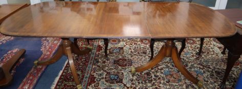 A Georgian style mahogany D end twin pillar extending dining table 230cm extended, one spare leaf