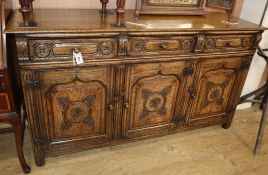 A reproduction carved and panelled oak sideboard W.168cm