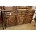 A reproduction carved and panelled oak sideboard W.168cm