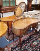 A pair of 1920's mahogany kidney shaped dressing tables, one with an oval mirror W.100cm