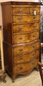 A Georgian style serpentine-fronted walnut tallboy fitted two short drawers and six long drawers H.