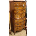 A Georgian style serpentine-fronted walnut tallboy fitted two short drawers and six long drawers H.