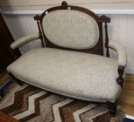 A late Victorian carved mahogany upholstered settee W.150cm