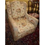 A late Victorian upholstered wing armchair