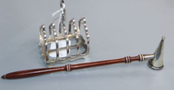A modern silver candle snuffer and a George V silver toastrack.